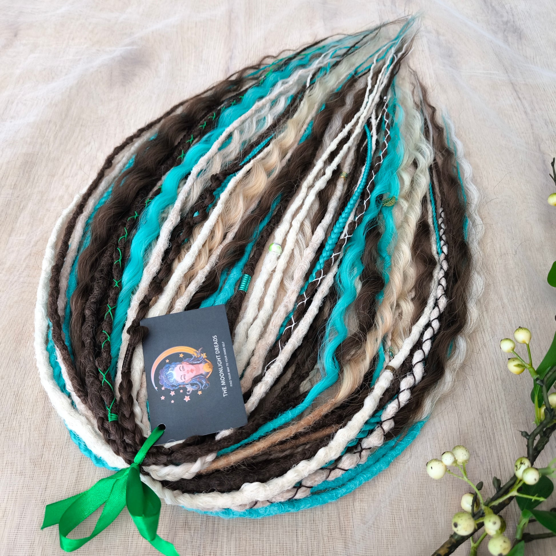 Brown, 2 shades of blonde, and turquoise green soft, lightweight, and reusable synthetic dreads, braids, and regular dreaded non-brushable curls (colors based on the Arctic Mocha brushable curls set)

The length is 22-24 inches (55-60 cm)
Dreaded part of curls: 4-5 inches
Thickness of braids ±0.8 cm