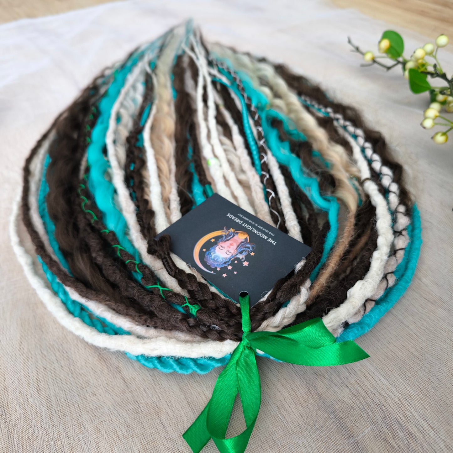 Brown, 2 shades of blonde, and turquoise green soft, lightweight, and reusable synthetic dreads, braids, and regular dreaded non-brushable curls (colors based on the Arctic Mocha brushable curls set)

The length is 22-24 inches (55-60 cm)
Dreaded part of curls: 4-5 inches
Thickness of braids ±0.8 cm