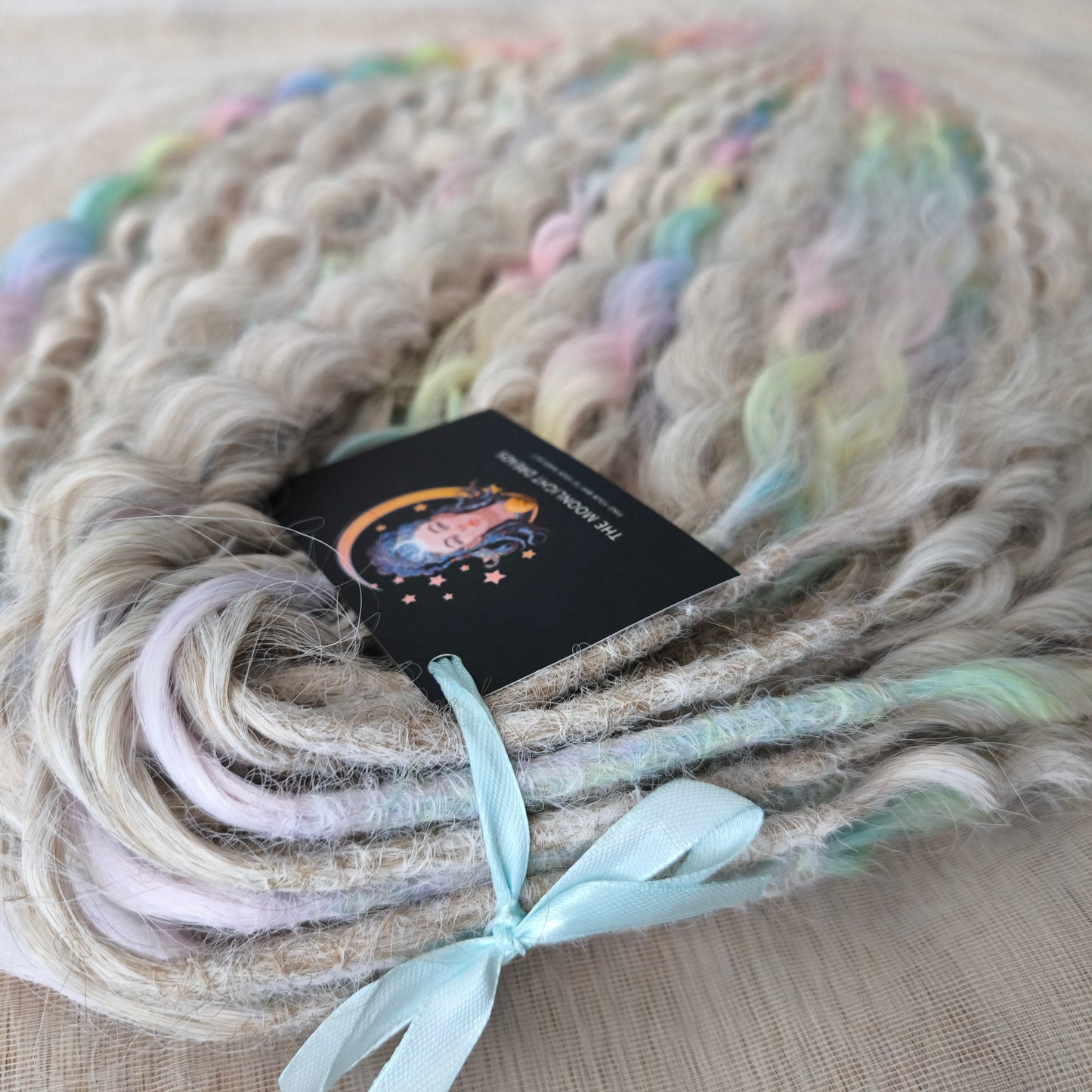 Pastel Unicorn: the mix of Platinum Blonde (2/3 parts of blonde) + and Pastel Rainbow/glitch/prism effect (1/3 part of rainbow) soft, lightweight, and reusable synthetic brushable double ended wavy dreadlocks (NOT BRUSHABLE)
