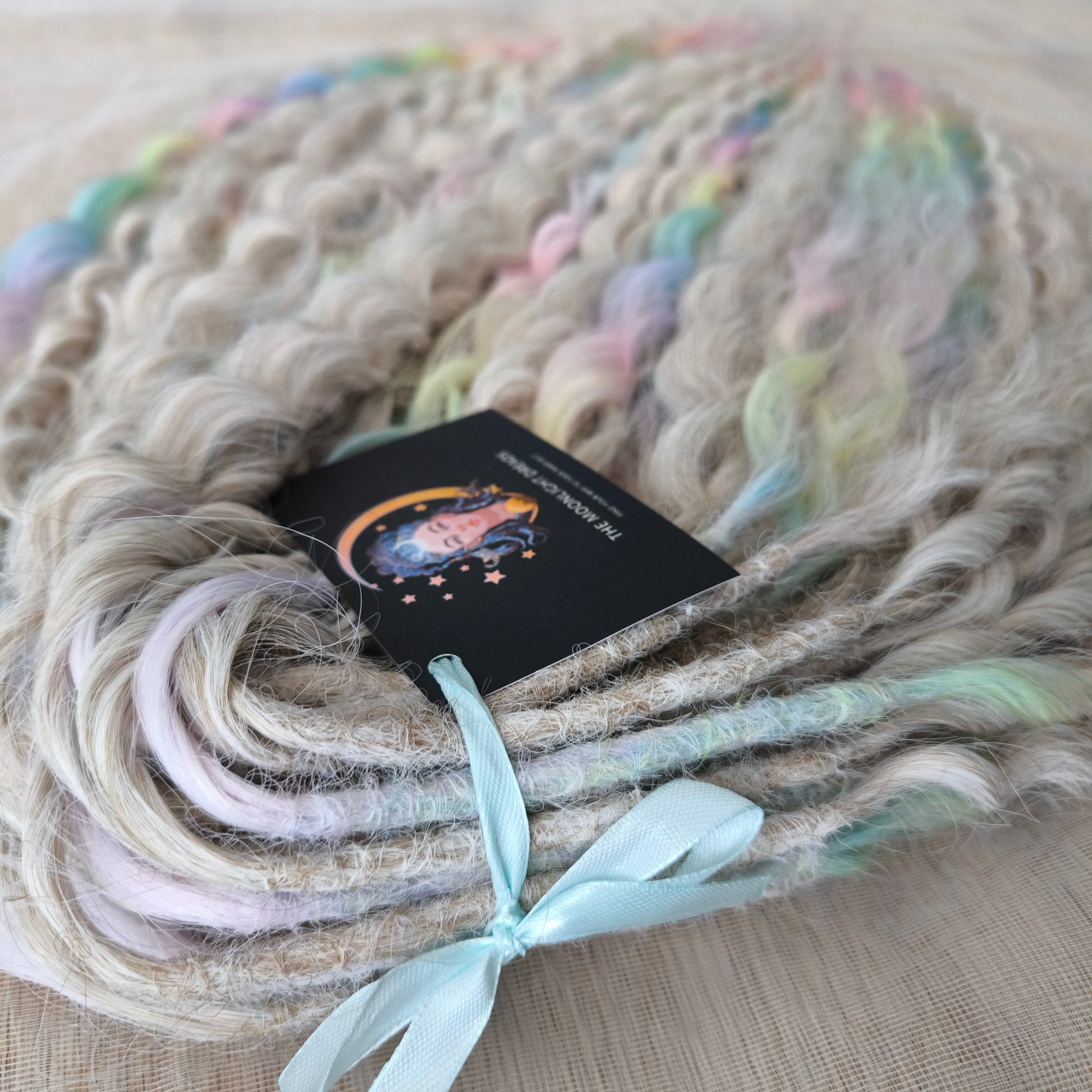 Pastel Unicorn: the mix of Platinum Blonde (2/3 parts of blonde) + and Pastel Rainbow/glitch/prism effect (1/3 part of rainbow) soft, lightweight, and reusable synthetic brushable double ended wavy dreadlocks (NOT BRUSHABLE)