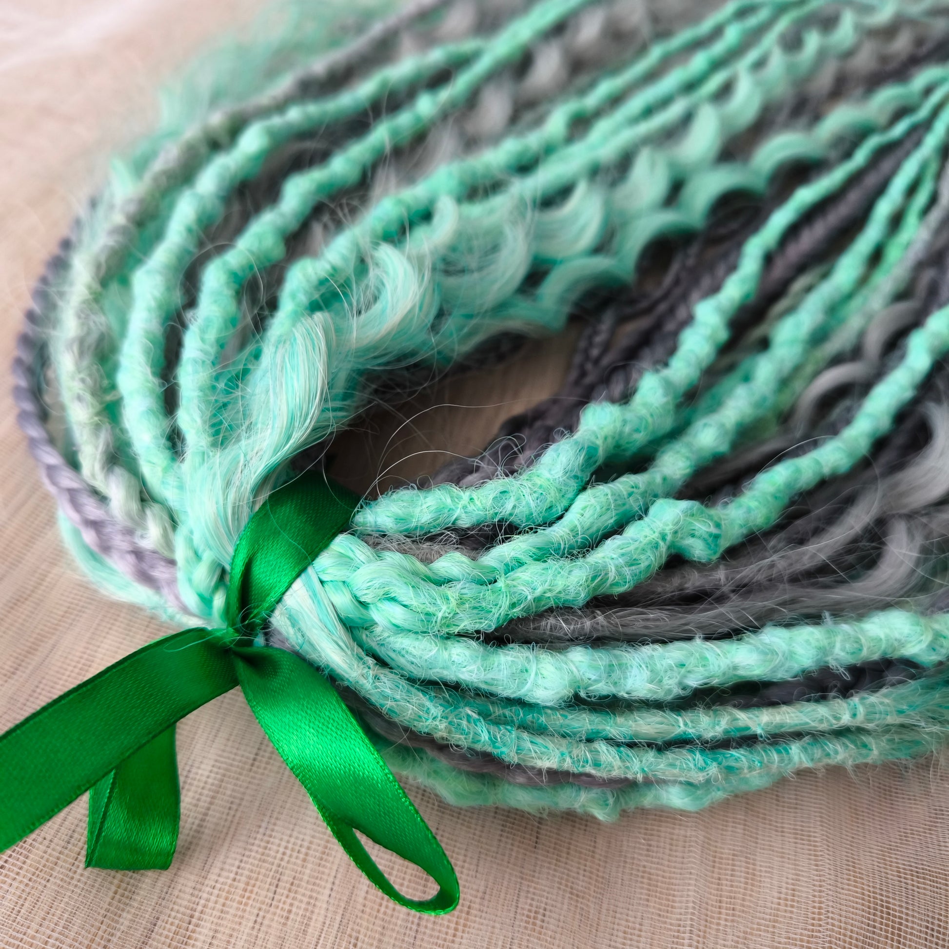 Mix of silver grey and mint green synthetic partial set of 34 double ended dreads, braids, dreaded curls.