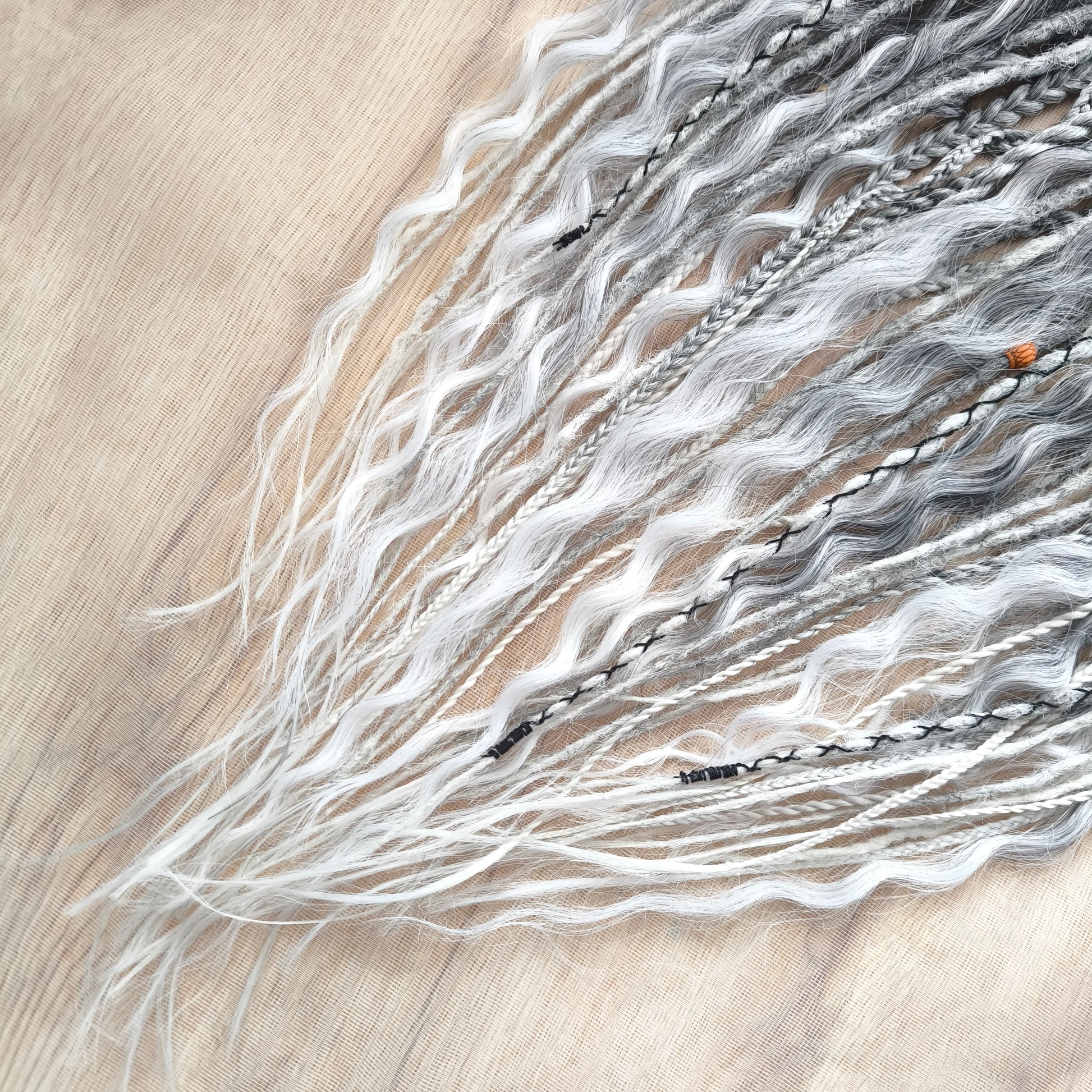 This set of synthetic dreadlocks combines elements of a Viking-inspired aesthetic.
Ombre from grey to platinum blonde double ended crochet dreads, braids, and Senegalese twists (curls optionally). Decoration is included. Reusable lightweight set made from high-quality synthetic hypoallergenic material kanekalon.

Standard length: ±22-24 inches (55-60 cm)
Thickness of dreads and braids: ±0.8 cm
Dreaded part of curls: ±3-4 inches (8-10 cm)