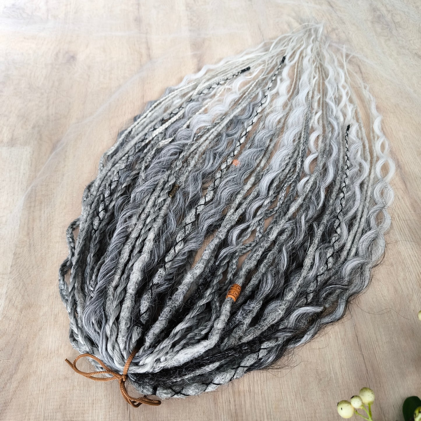 This set of synthetic dreadlocks combines elements of a Viking-inspired aesthetic.
Ombre from grey to platinum blonde double ended crochet dreads, braids, and Senegalese twists (curls optionally). Decoration is included. Reusable lightweight set made from high-quality synthetic hypoallergenic material kanekalon.

Standard length: ±22-24 inches (55-60 cm)
Thickness of dreads and braids: ±0.8 cm
Dreaded part of curls: ±3-4 inches (8-10 cm)