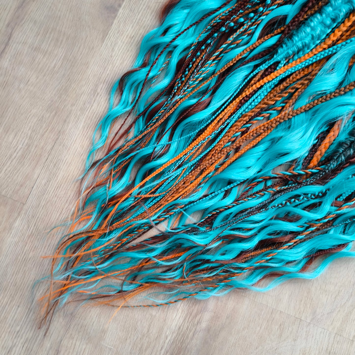 Ginger Sky: soft, lightweight, and reusable double ended various DE synthetic braids and regular dreaded brushable curls. A mix of turquoise green, red, copper, and orange colors.

The length is 22-24 inches (55-60 cm)
Dreaded part of curls: 4-5 inches
Thickness of braids ±0.8 cm