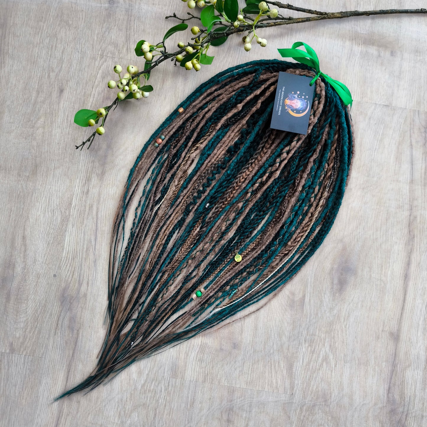 synthetic partial set of double ended crochet dreadlocks, braids, Senegalese twists in forest green and a few tints of brown colors.