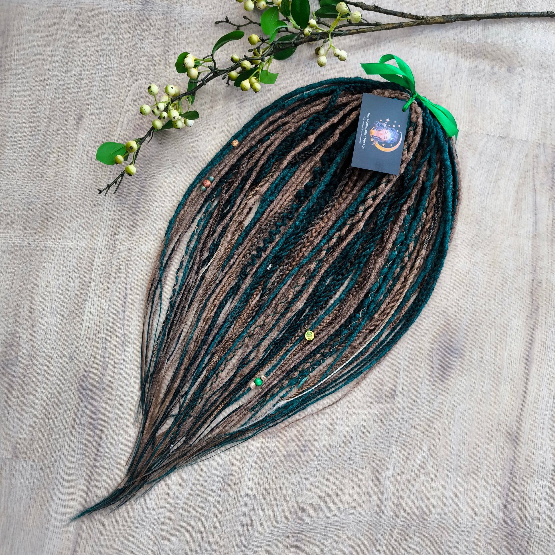 synthetic partial set of double ended crochet dreadlocks, braids, Senegalese twists in forest green and a few tints of brown colors.