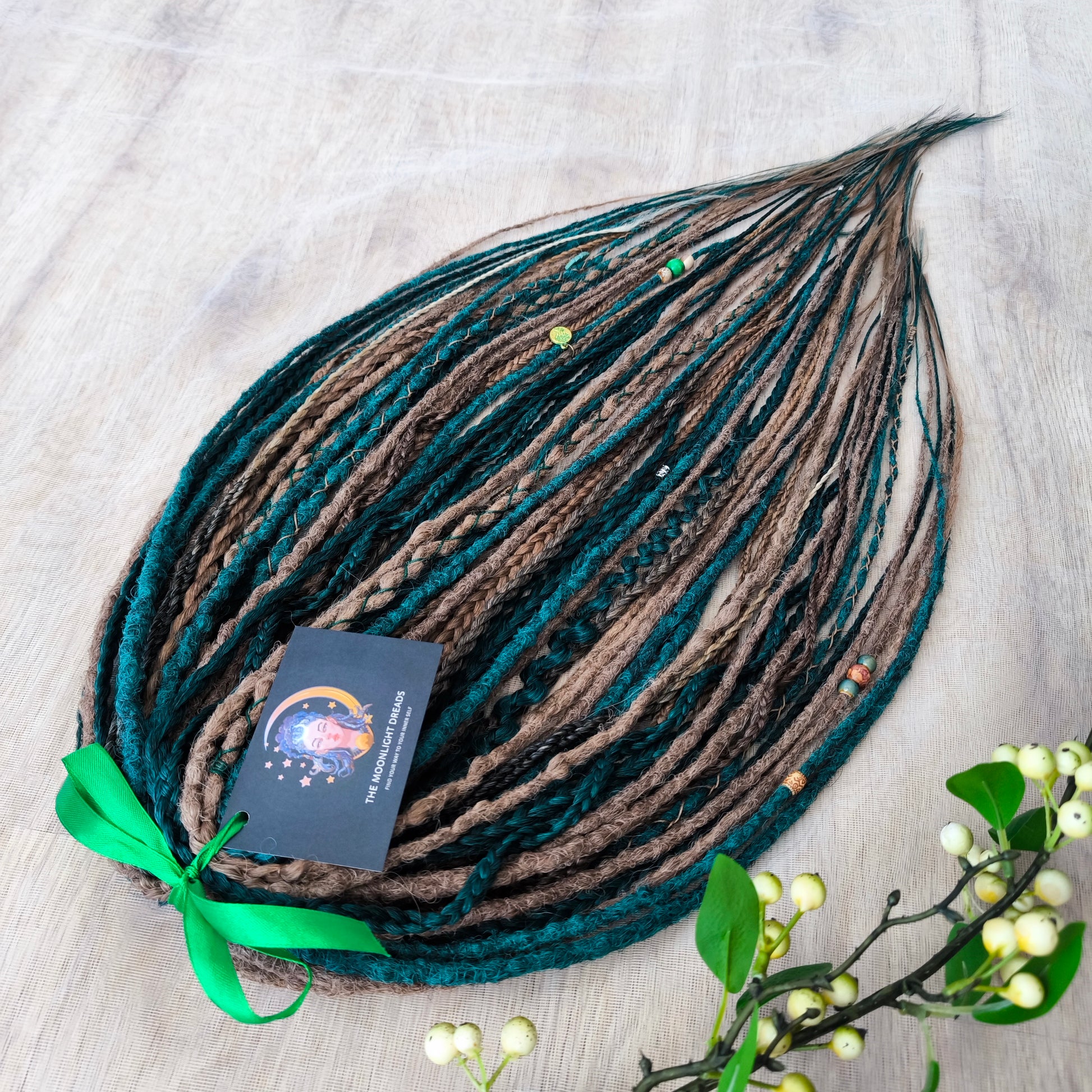 synthetic set of double ended crochet dreadlocks, braids, Senegalese twists in forest green and a few tints of brown colors.