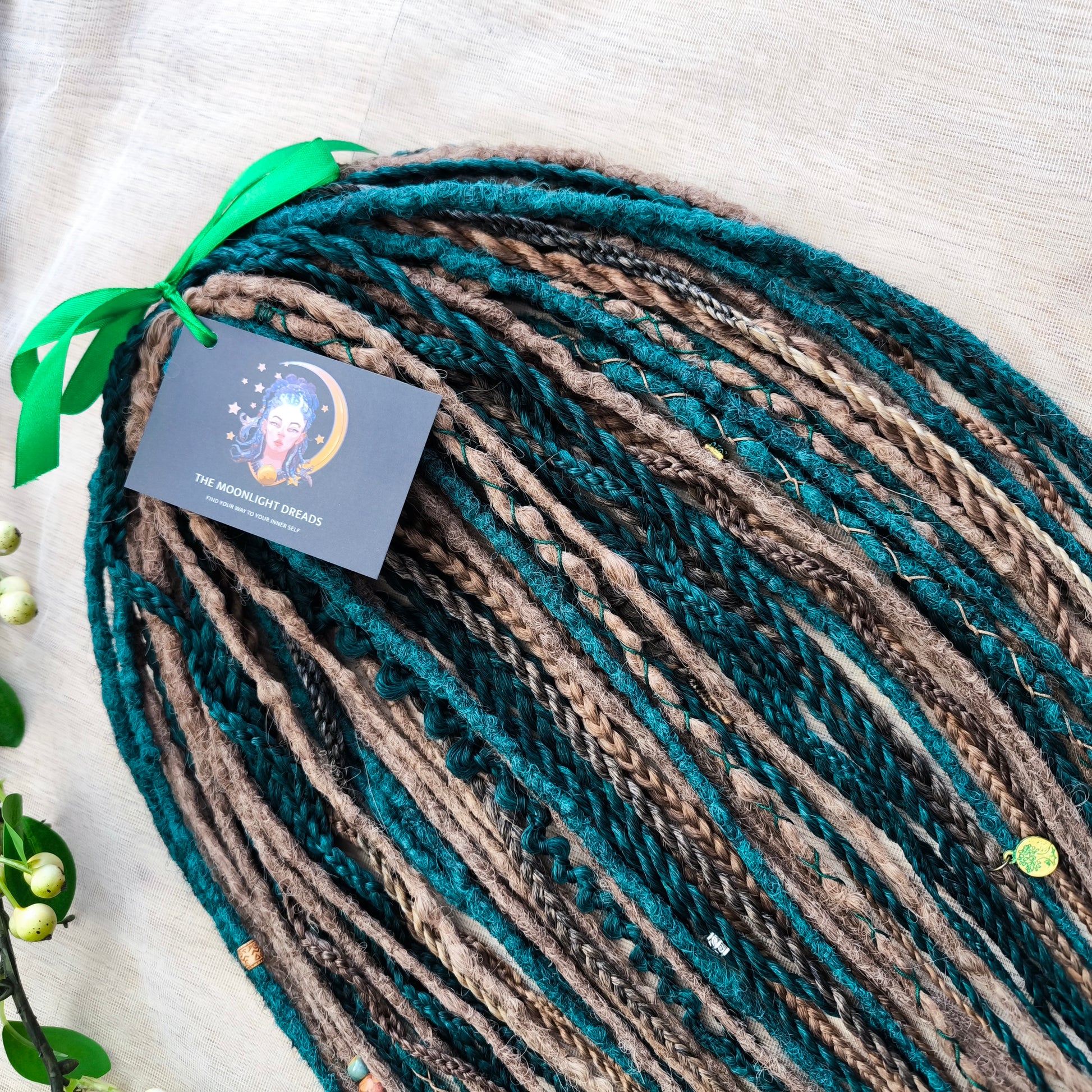 synthetic set of double ended crochet dreadlocks, braids, Senegalese twists in forest green and a few tints of brown colors.