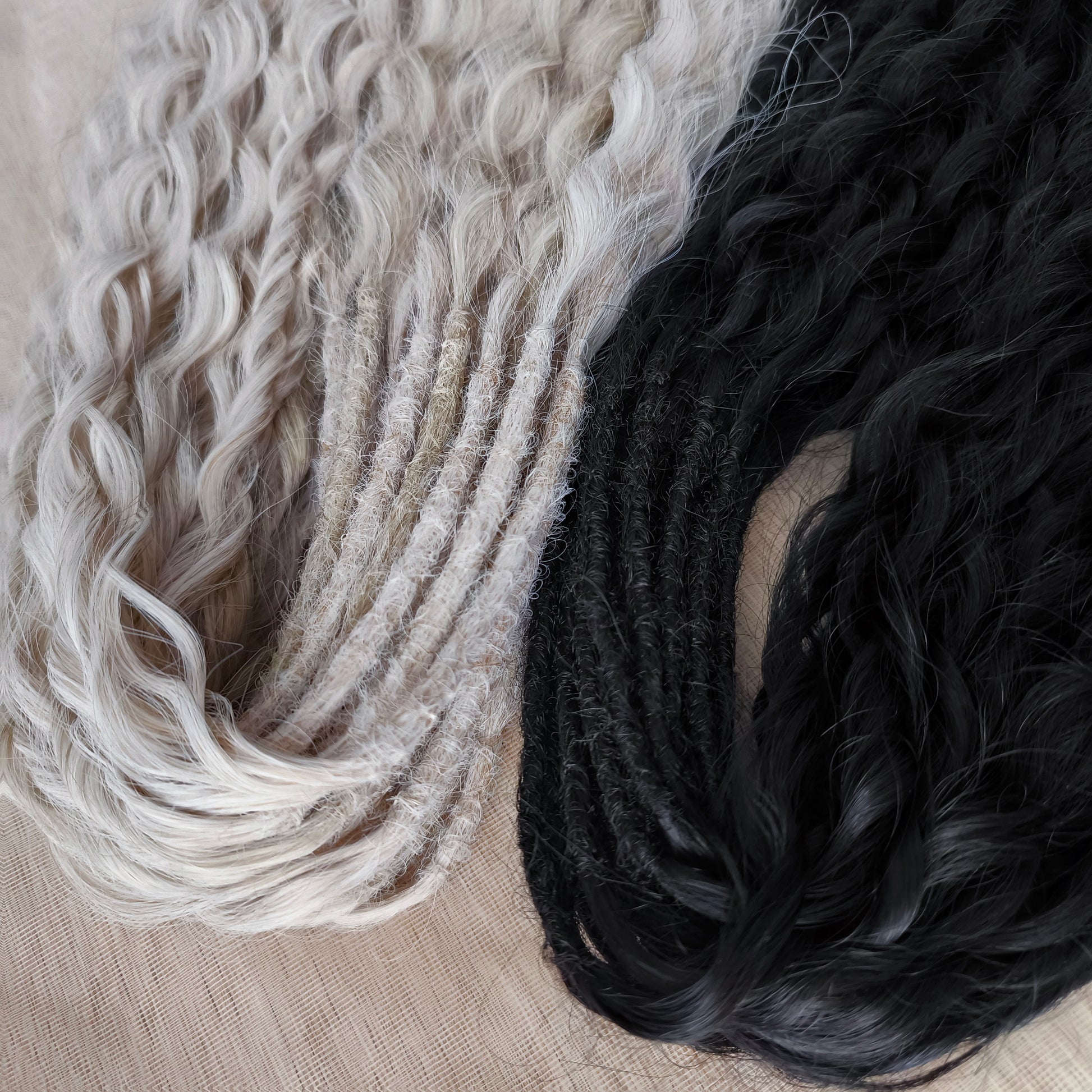 Black and white/blonde set of 62 double ended synthetic non-brushable dreaded curls.

Length: ±28-30 inches (70-75 cm)
Dreaded part of curls ±3-4 inches (8-10 cm)
Weight: ±420 gr (15 oz)
