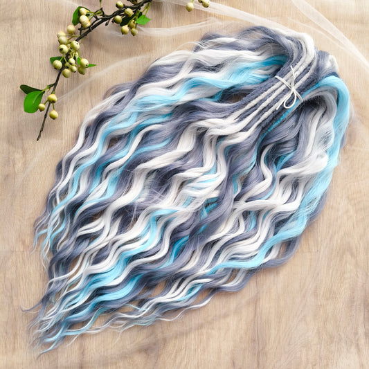 Let your hair channel the raw beauty of the Arctic with this striking icy blend. Arctic Ice features cool-toned waves in glacier blue, soft white, and smoky gray, flowing together like frozen mist over a winter sea.

Elegant, bold, and ethereal — this set is perfect for anyone who loves a crisp, dramatic look with an icy twist.
