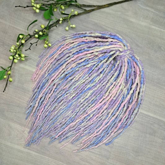 Pastel Cloud - a soft pastel mix of lavender, baby blue, blush pink, and creamy blonde. Soft, lightweight, and reusable 49 double ended synthetic bumpy dreadlocks with blunt ends give a calm, airy look.

Length: ≈15-16 inches (≈38-40 cm)
Thickness of dreads and braids: ≈0.8-1 cm
Weight: ≈260 gr (≈9,17 oz)