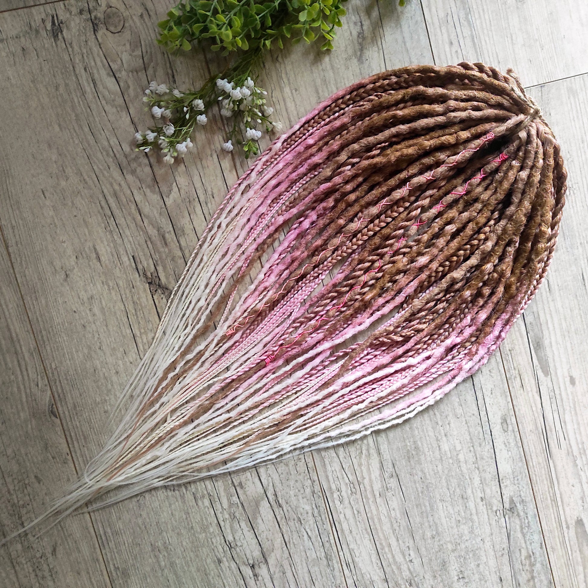IceCream – double ended synthetic crochet dreadlocks and braids.
At the roots, the color starts with warm caramel and nude blonde tones, gradually transitioning towards the ends into delicate pastel pink and platinum blonde. The gradient is smooth and airy, with a light pastel feel and no harsh contrasts.

A soft, creamy blend inspired by strawberry and vanilla ice cream in a waffle cone.