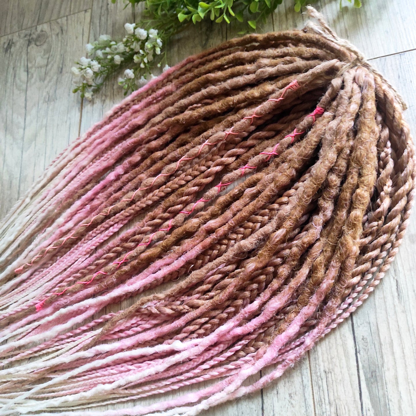 IceCream – double ended synthetic crochet dreadlocks and braids.
At the roots, the color starts with warm caramel and nude blonde tones, gradually transitioning towards the ends into delicate pastel pink and platinum blonde. The gradient is smooth and airy, with a light pastel feel and no harsh contrasts.

A soft, creamy blend inspired by strawberry and vanilla ice cream in a waffle cone.