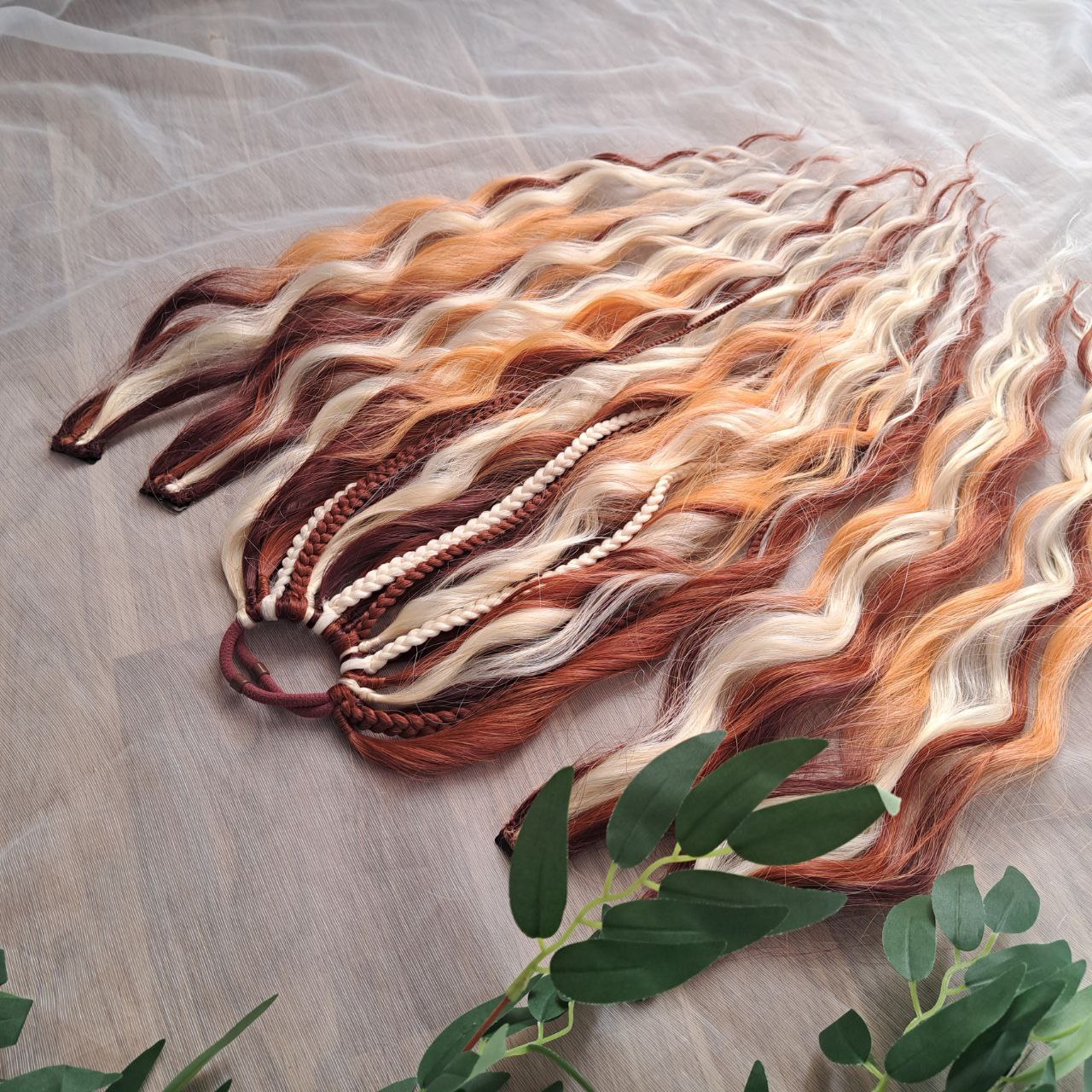 Braids, dreads, and curls on an elastic band — a simple way to transform a ponytail without installing a set. Easy to put on and remove whenever you like. A great option if you can’t install dreads or braids. Also, a perfect gift for kids 🎁

These scrunchies add instant length, volume, and texture — whether you prefer bold colors or natural shades.

Length: 22–24 inches.
Each hair tie includes 12–14 pieces, depending on the style.

Choose from the available designs shown, or contact us for a custom order.