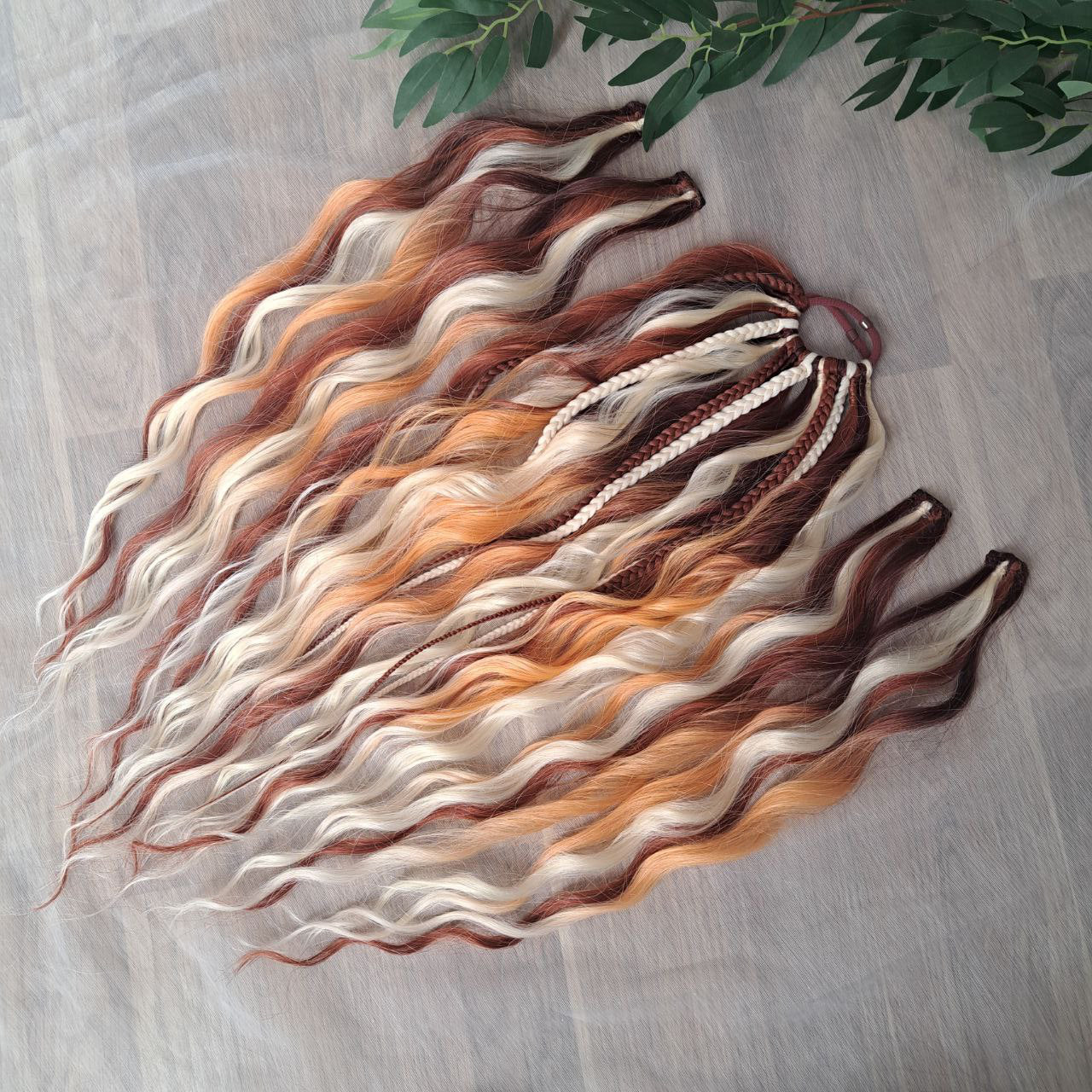 Braids, dreads, and curls on an elastic band — a simple way to transform a ponytail without installing a set. Easy to put on and remove whenever you like. A great option if you can’t install dreads or braids. Also, a perfect gift for kids 🎁

These scrunchies add instant length, volume, and texture — whether you prefer bold colors or natural shades.

Length: 22–24 inches.
Each hair tie includes 12–14 pieces, depending on the style.

Choose from the available designs shown, or contact us for a custom order.