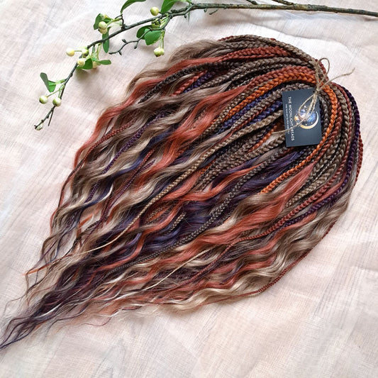 Inspired by the original Spiced Ember set, this version combines regular braids and curls with a braided middle, all in the warmth and depth of autumn hues. Here, rich amber and copper shades are balanced by earthy brown, honey caramel, and subtle chestnut notes — creating a natural yet vibrant color harmony.

Standard length: ±22-24 inches (55-60 cm)
Thickness of braids: ±0.8 cm
Braided part of curls: ±4–5 inches folded (total ±8–10 inches)