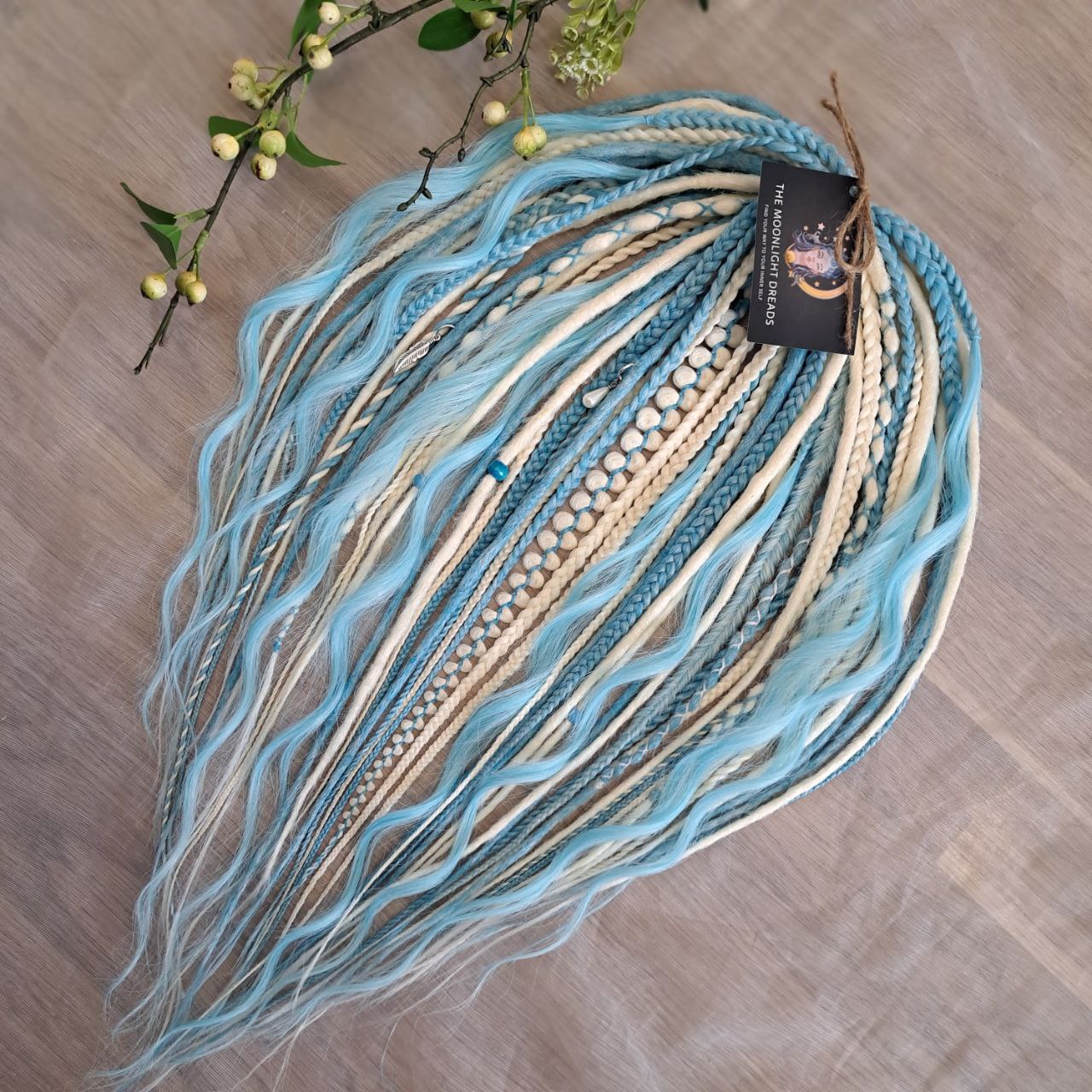 Ice Flow is a soft, lightweight, and reusable set of double ended synthetic crochet dreadlocks, various braids, and dreaded curls. A fresh blend of icy blue and soft white with a smooth, airy flow of color.

Standard length: 22-24 inches (55-60 cm)
Thickness of dreads and braids: ~0.8 cm
Dreaded part of curls ~3-4 inches (8-10 cm)