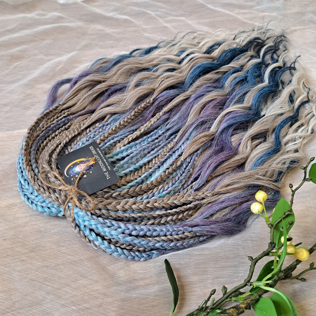 Soft, lightweight, and reusable double ended synthetic brushable curls. Ombre from ash to platinum blonde, and a cool transition from dusty blue into lavender and navy blue.