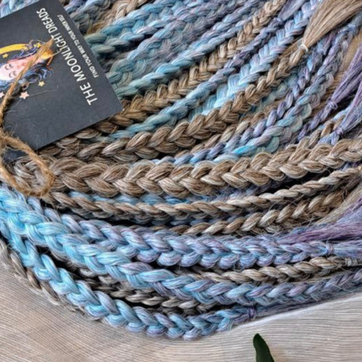 Soft, lightweight, and reusable double ended synthetic brushable curls. Ombre from ash to platinum blonde, and a cool transition from dusty blue into lavender and navy blue.