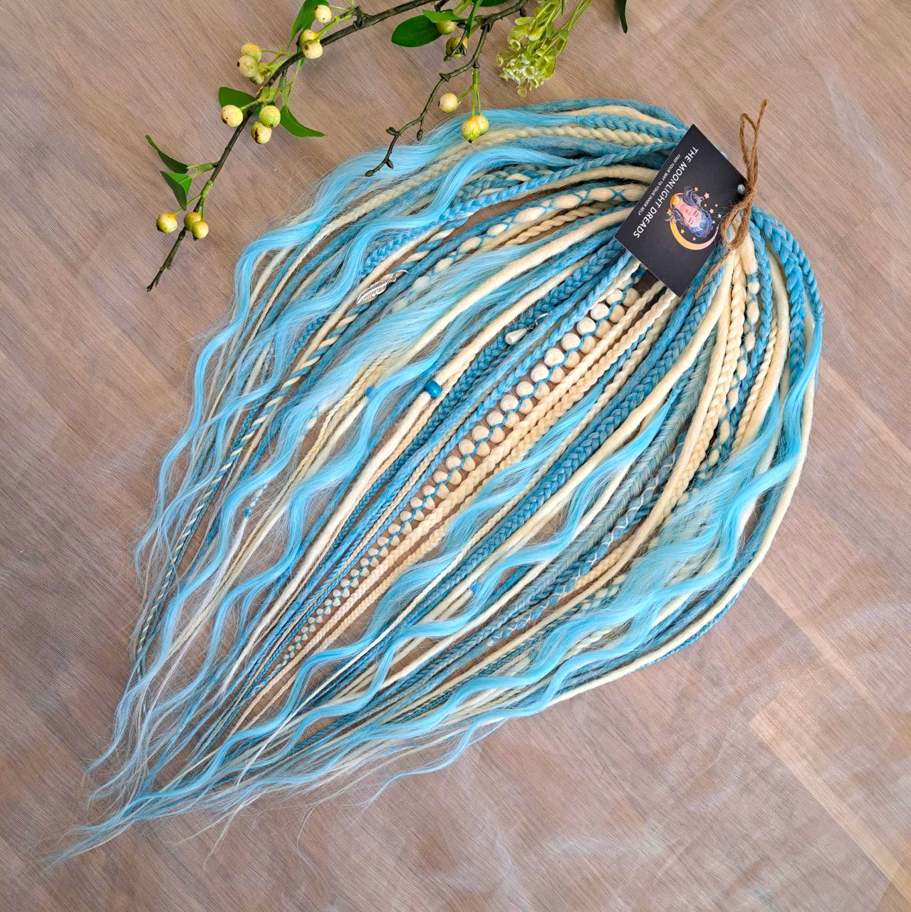 Ice Flow is a soft, lightweight, and reusable set of double ended synthetic crochet dreadlocks, various braids, and dreaded curls. A fresh blend of icy blue and soft white with a smooth, airy flow of color.

Standard length: 22-24 inches (55-60 cm)
Thickness of dreads and braids: ~0.8 cm
Dreaded part of curls ~3-4 inches (8-10 cm)