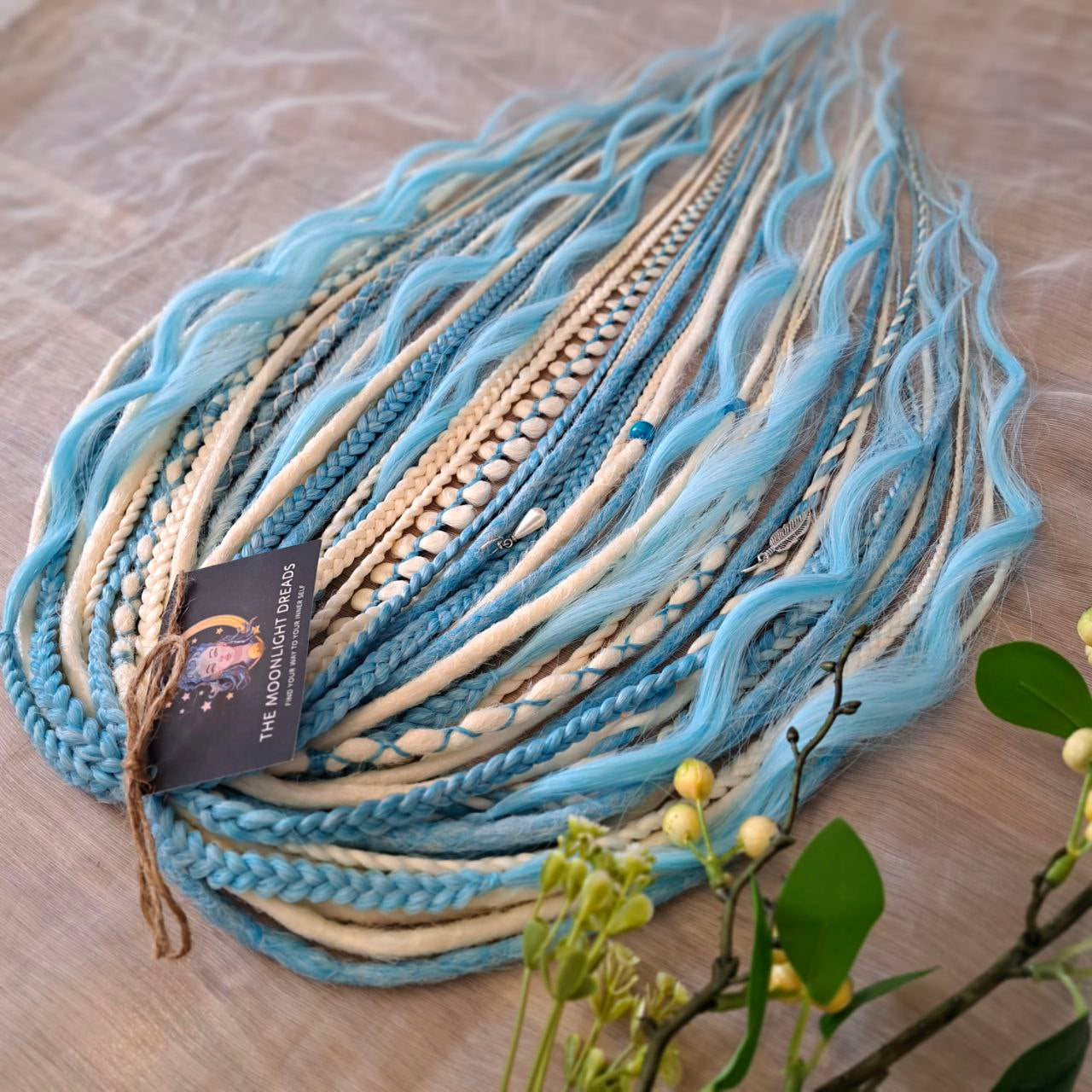 Ice Flow is a soft, lightweight, and reusable set of double ended synthetic crochet dreadlocks, various braids, and dreaded curls. A fresh blend of icy blue and soft white with a smooth, airy flow of color.

Standard length: 22-24 inches (55-60 cm)
Thickness of dreads and braids: ~0.8 cm
Dreaded part of curls ~3-4 inches (8-10 cm)