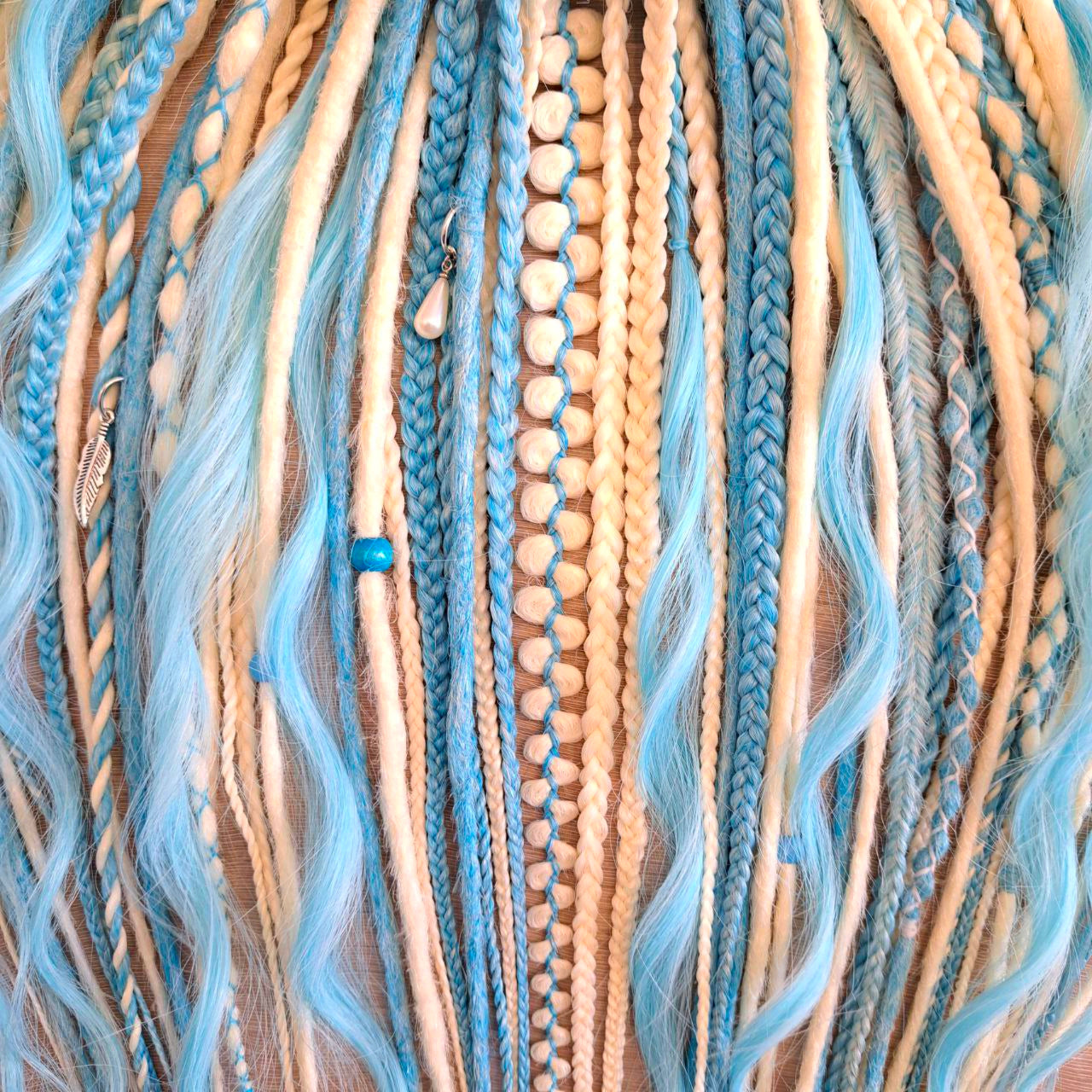Ice Flow is a soft, lightweight, and reusable set of double ended synthetic crochet dreadlocks, various braids, and dreaded curls. A fresh blend of icy blue and soft white with a smooth, airy flow of color.

Standard length: 22-24 inches (55-60 cm)
Thickness of dreads and braids: ~0.8 cm
Dreaded part of curls ~3-4 inches (8-10 cm)
