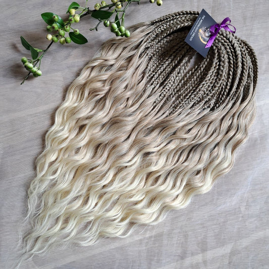 Ready to ship: soft, lightweight, and reusable 50 double ended synthetic brushable curls with braided middle. Soft natural gradient in warm neutral tones.

Roots in muted dark blonde with a subtle ash-beige (taupe) undertone, gradually blending into a warm beige-wheat blonde, and finishing in a light creamy, almost platinum vanilla blonde at the ends.