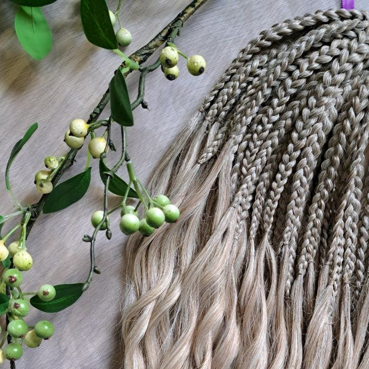 Ready to ship: soft, lightweight, and reusable 50 double ended synthetic brushable curls with braided middle. Soft natural gradient in warm neutral tones.

Roots in muted dark blonde with a subtle ash-beige (taupe) undertone, gradually blending into a warm beige-wheat blonde, and finishing in a light creamy, almost platinum vanilla blonde at the ends.