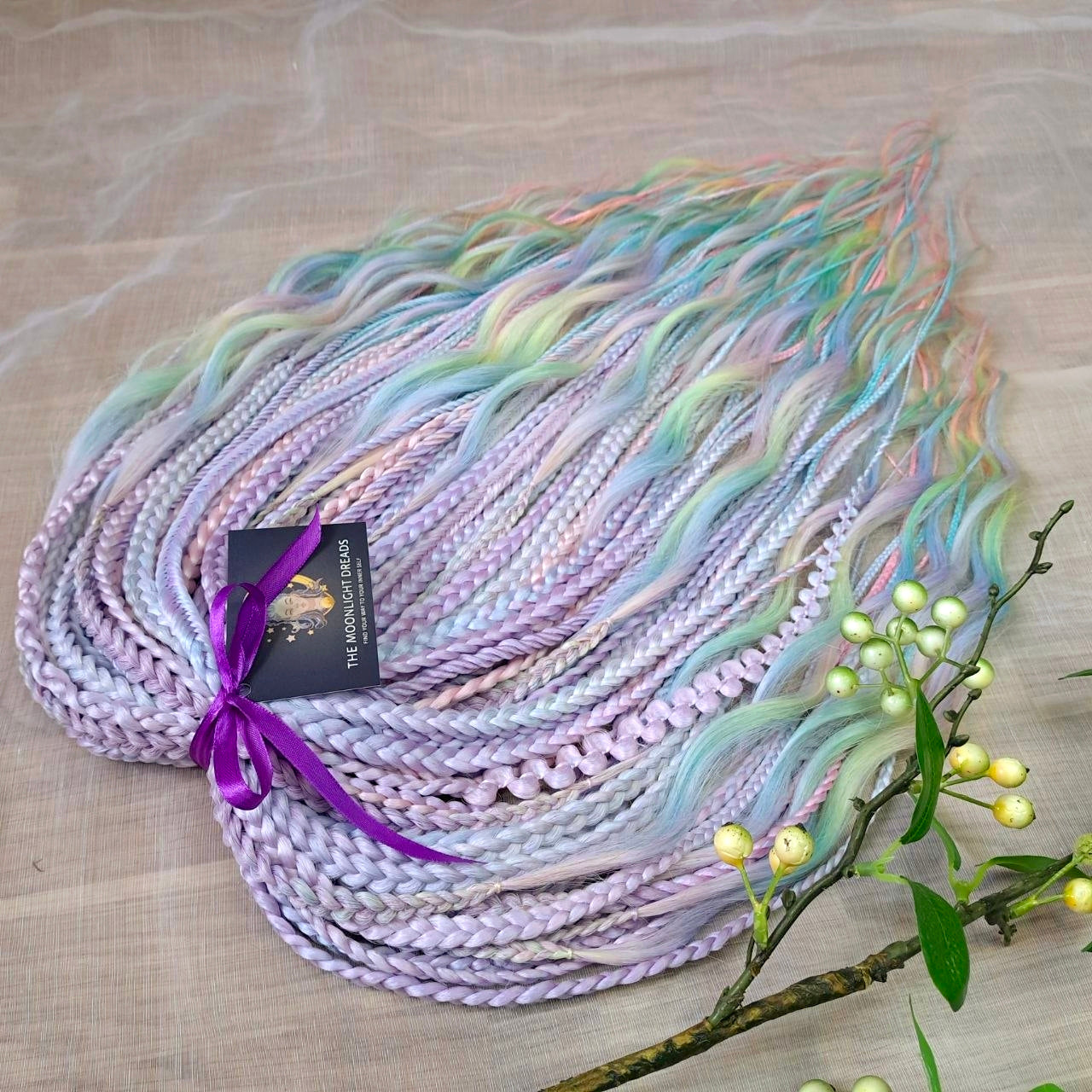 Pastel Prism: soft, lightweight, and reusable 52 double ended various synthetic braids, and braided middle curls in a soft blend of pastel lavender, mint, baby blue, and blush tones.

The length is 22-24 inches (55-60 cm)
Thickness of braids ±0.8 cm
Weight: ±365 gr (11,7 oz)