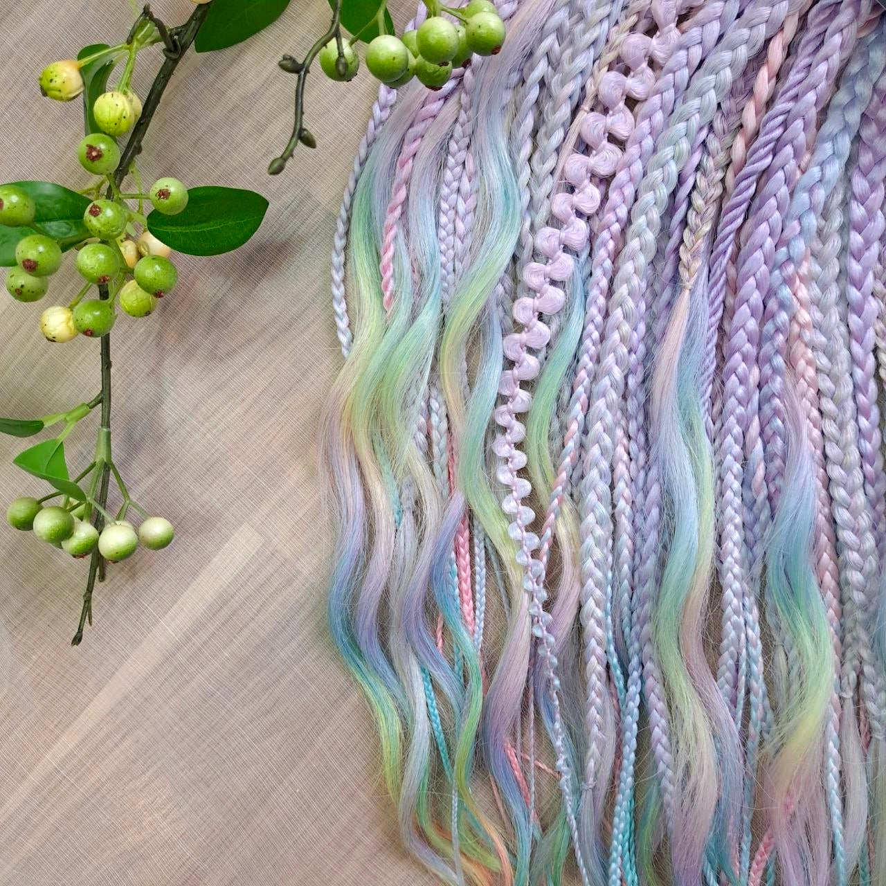 Pastel Prism: soft, lightweight, and reusable 52 double ended various synthetic braids, and braided middle curls in a soft blend of pastel lavender, mint, baby blue, and blush tones.

The length is 22-24 inches (55-60 cm)
Thickness of braids ±0.8 cm
Weight: ±365 gr (11,7 oz)