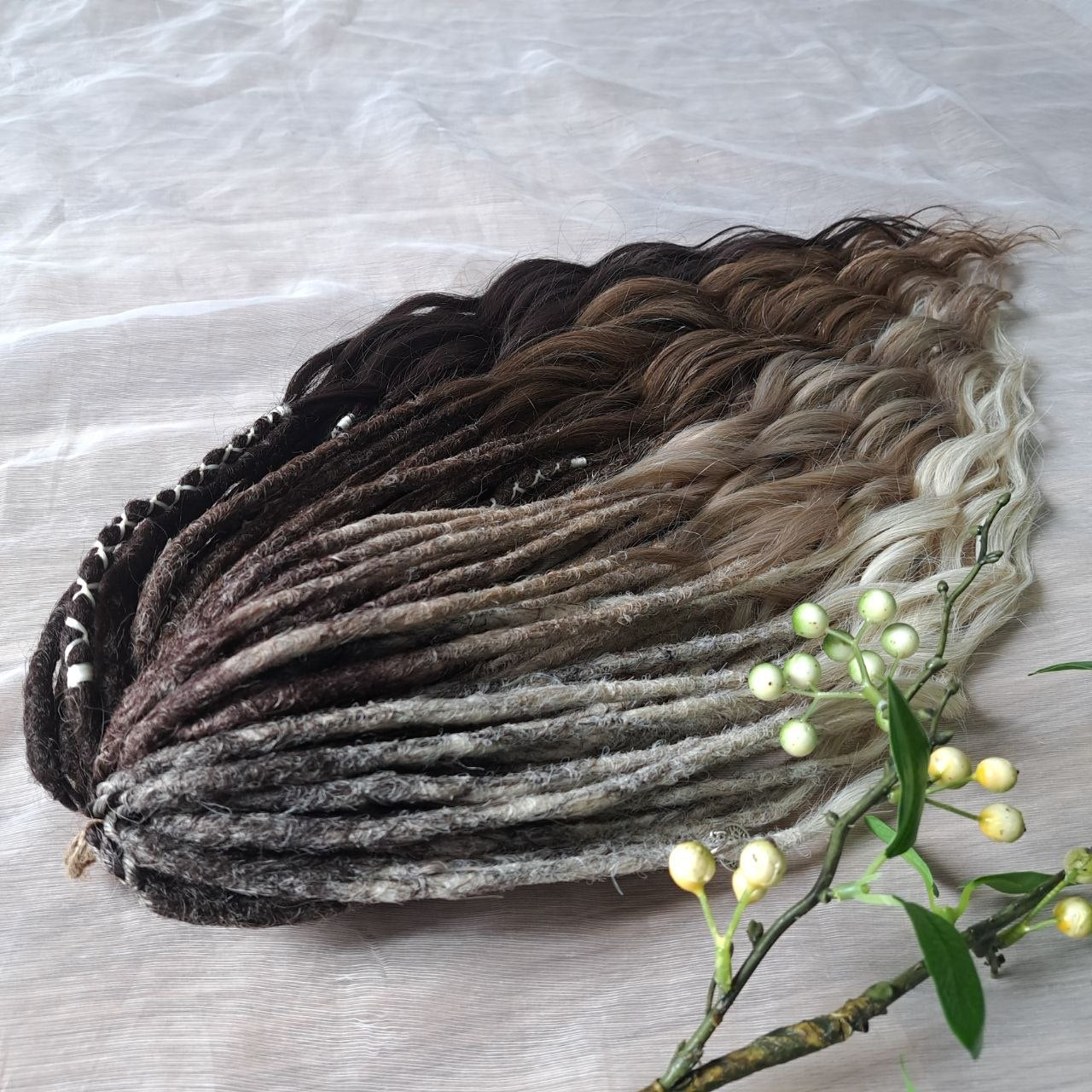 Soft, lightweight,  reusable synthetic double ended crochet dreadlocks, with curly brushable ends (colors based on the colors from the Smoky Mix set):

- chocolate brown;
- ombre from medium to light brown;
- ashy wheat blonde with dark roots;
- light blonde with dark roots.
