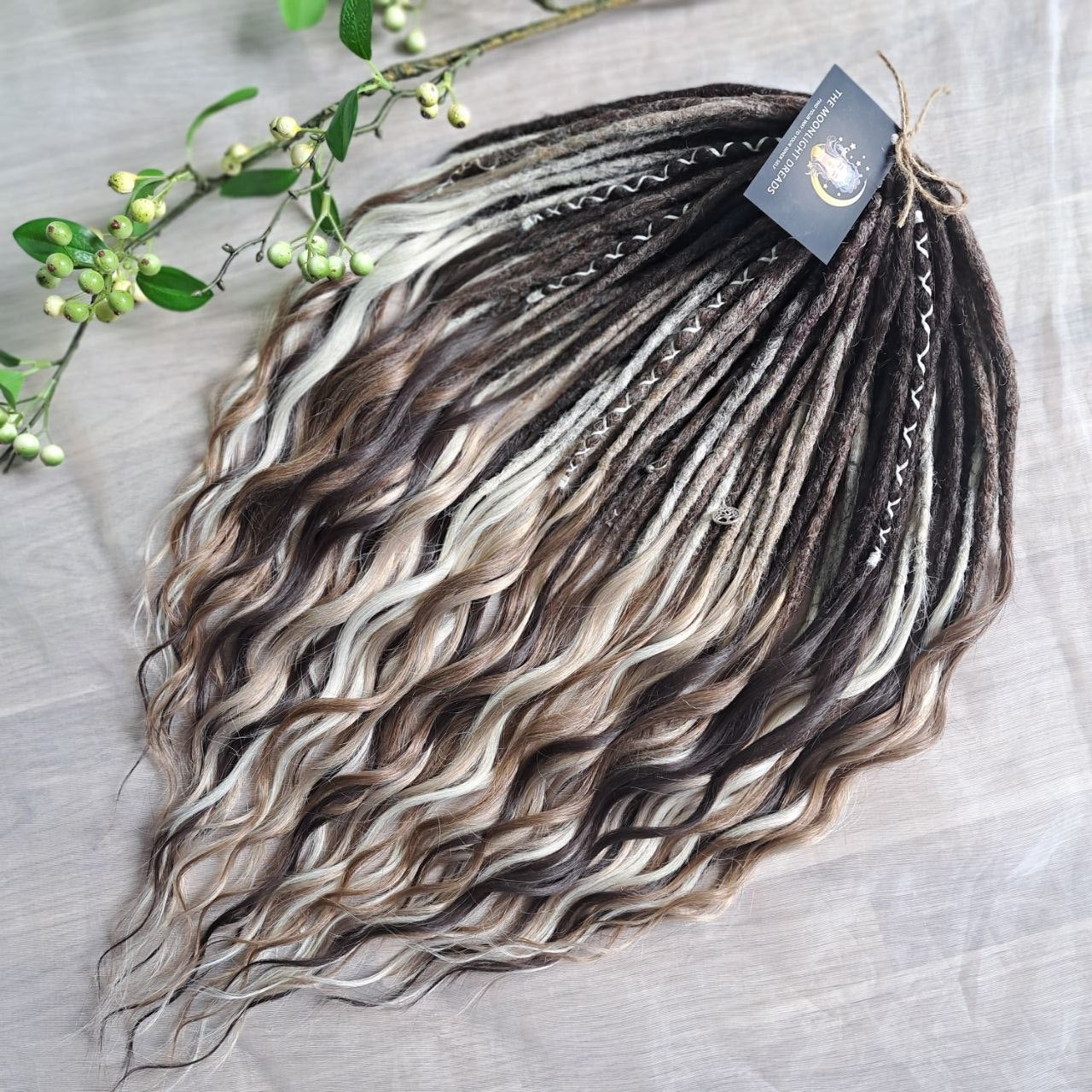 Soft, lightweight,  reusable synthetic double ended crochet dreadlocks, with curly brushable ends (colors based on the colors from the Smoky Mix set):

- chocolate brown;
- ombre from medium to light brown;
- ashy wheat blonde with dark roots;
- light blonde with dark roots.
