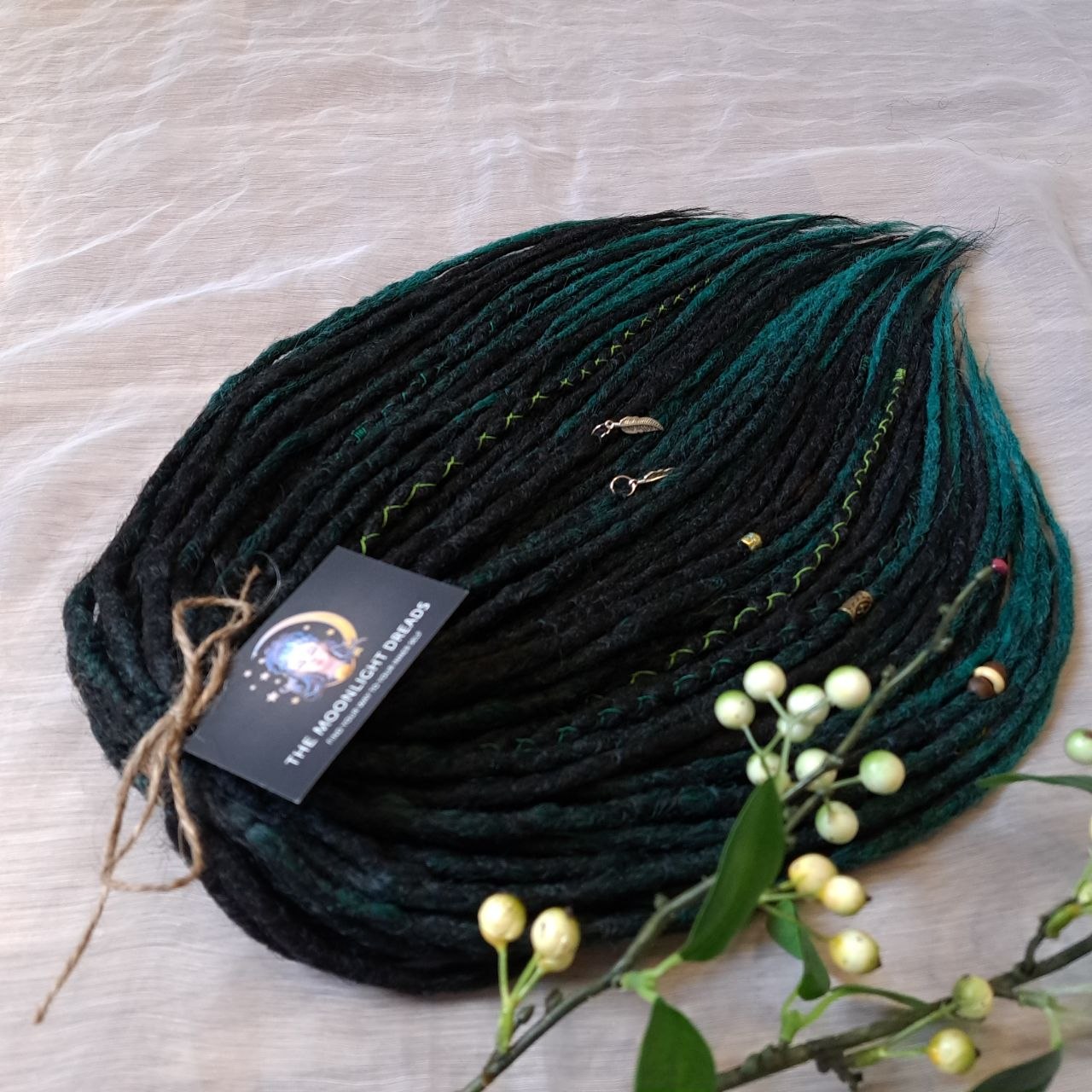 Deep forest dreads - Black and ombre emerald synthetic set of 50 double ended crochet dreadlocks.

Length: ±18-20 inches (45-50 cm)
Thickness of dreads and braids: ±0.8-1 cm
Weight with decoration: ±315 gr (11 oz)