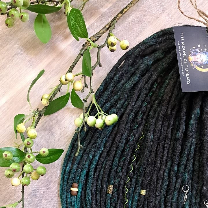 Deep forest dreads - Black and ombre emerald synthetic set of 50 double ended crochet dreadlocks.

Length: ±18-20 inches (45-50 cm)
Thickness of dreads and braids: ±0.8-1 cm
Weight with decoration: ±315 gr (11 oz)