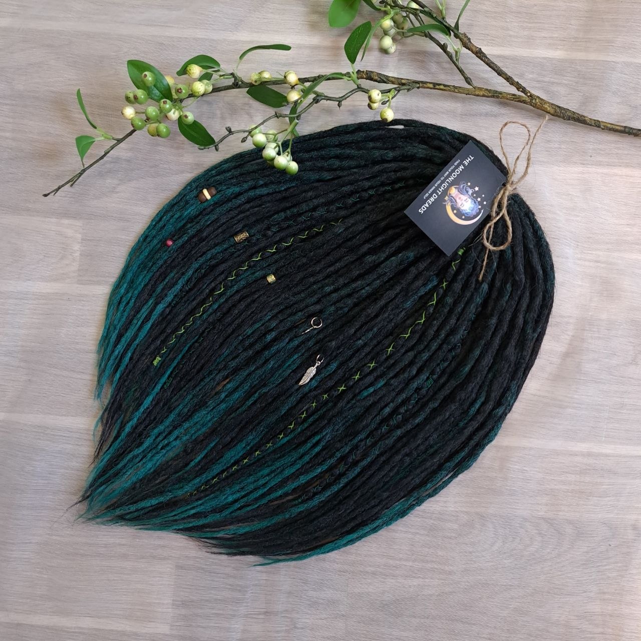 Deep forest dreads - Black and ombre emerald synthetic set of 50 double ended crochet dreadlocks.

Length: ±18-20 inches (45-50 cm)
Thickness of dreads and braids: ±0.8-1 cm
Weight with decoration: ±315 gr (11 oz)