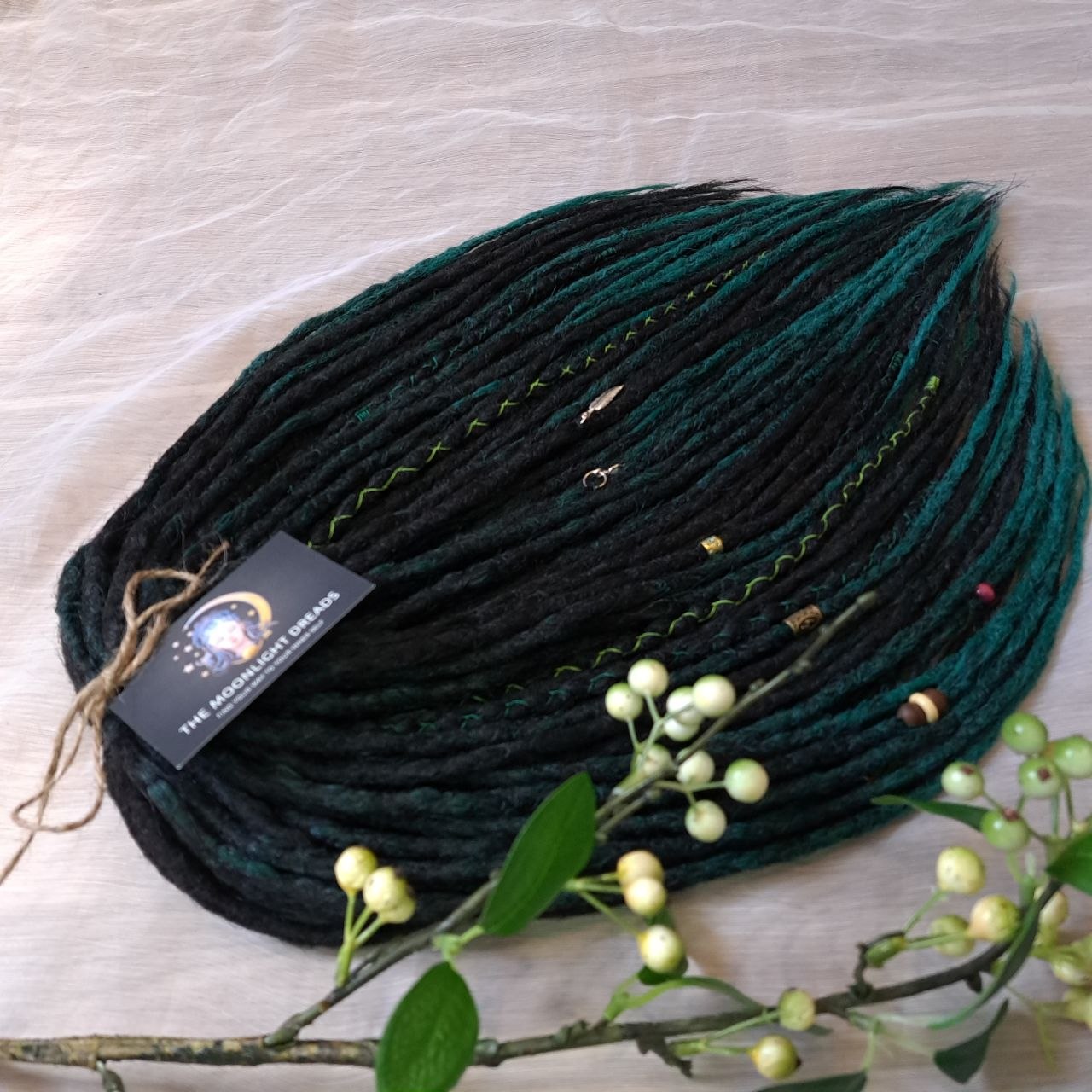 Deep forest dreads - Black and ombre emerald synthetic set of 50 double ended crochet dreadlocks.

Length: ±18-20 inches (45-50 cm)
Thickness of dreads and braids: ±0.8-1 cm
Weight with decoration: ±315 gr (11 oz)