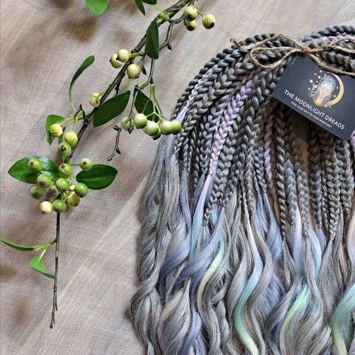 Moon Pearl - soft, lightweight, and reusable synthetic brushable double ended wavy dreadlocks (regular dreaded, braided middle, or push-up).

A blend of pearl grey, icy blue, soft mint, lavender, and blush pink - subtle, airy, and full of depth. The pastel shades appear gently throughout the set, creating a shimmering effect without overpowering the base color.