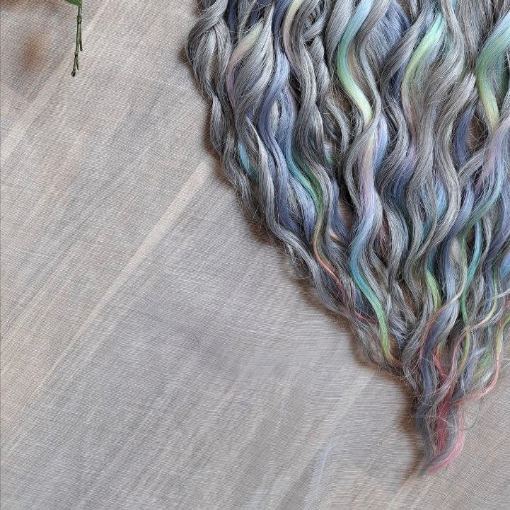 Moon Pearl - soft, lightweight, and reusable synthetic brushable double ended wavy dreadlocks (regular dreaded, braided middle, or push-up).

A blend of pearl grey, icy blue, soft mint, lavender, and blush pink - subtle, airy, and full of depth. The pastel shades appear gently throughout the set, creating a shimmering effect without overpowering the base color.