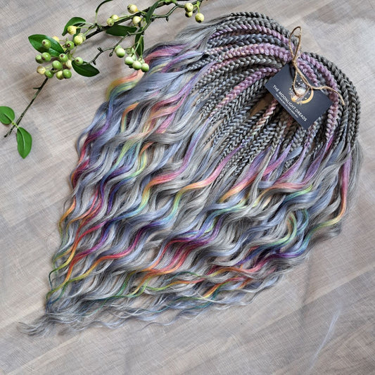 Silver Rainbow - soft, lightweight, and reusable synthetic brushable double ended wavy dreadlocks (regular dreaded, braided middle, or push-up).

A silver-grey base with vibrant rainbow accents. Bright pops of color stand out against the cool smoky background, creating a playful yet balanced look.