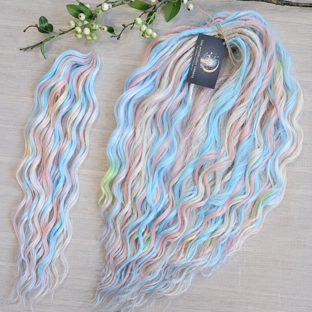 Ready to Ship: Cotton Candy - soft, lightweight, and reusable 50 double ended synthetic brushable dreaded curls. A blend of platinum blonde, sky blue, pink, and rainbow colors creates a light, airy look full of soft color transitions.

Length: 22-24 inches (55-60 cm)
Dreaded part (one-side dreaded): ±4-5 inches (±10-12 cm)
Weight: ±300 gr (10,6 oz)