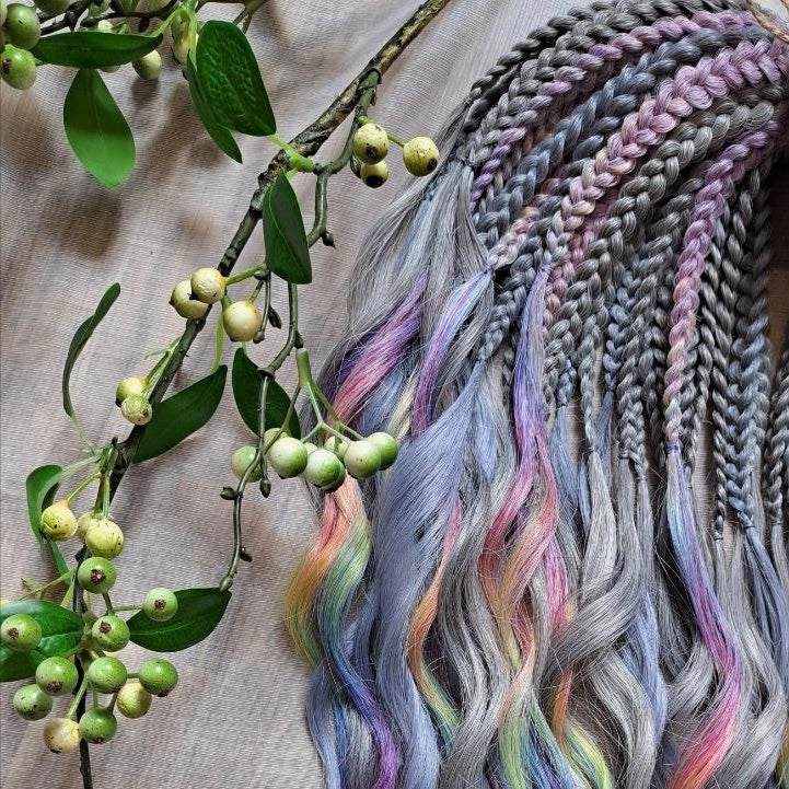 Silver Rainbow - soft, lightweight, and reusable synthetic brushable double ended wavy dreadlocks (regular dreaded, braided middle, or push-up).

A silver-grey base with vibrant rainbow accents. Bright pops of color stand out against the cool smoky background, creating a playful yet balanced look.