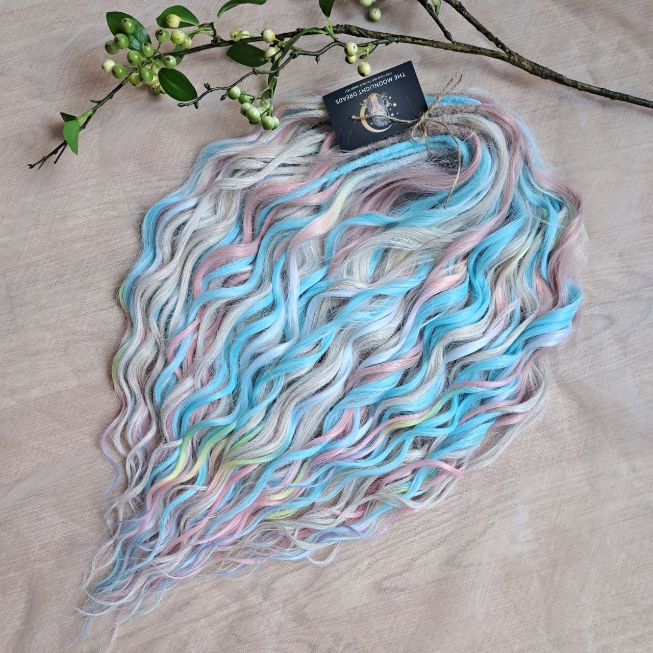Ready to Ship: Cotton Candy - soft, lightweight, and reusable 50 double ended synthetic brushable dreaded curls. A blend of platinum blonde, sky blue, pink, and rainbow colors creates a light, airy look full of soft color transitions.

Length: 22-24 inches (55-60 cm)
Dreaded part (one-side dreaded): ±4-5 inches (±10-12 cm)
Weight: ±300 gr (10,6 oz)