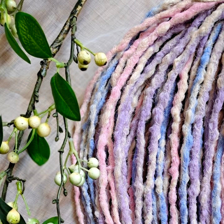 Pastel Cloud - a soft pastel mix of lavender, baby blue, blush pink, and creamy blonde. Soft, lightweight, and reusable 49 double ended synthetic bumpy dreadlocks with blunt ends give a calm, airy look.

Length: ≈15-16 inches (≈38-40 cm)
Thickness of dreads and braids: ≈0.8-1 cm
Weight: ≈260 gr (≈9,17 oz)