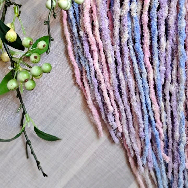 Pastel Cloud - a soft pastel mix of lavender, baby blue, blush pink, and creamy blonde. Soft, lightweight, and reusable 49 double ended synthetic bumpy dreadlocks with blunt ends give a calm, airy look.

Length: ≈15-16 inches (≈38-40 cm)
Thickness of dreads and braids: ≈0.8-1 cm
Weight: ≈260 gr (≈9,17 oz)