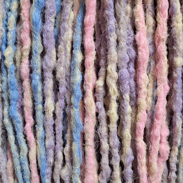 Pastel Cloud - a soft pastel mix of lavender, baby blue, blush pink, and creamy blonde. Soft, lightweight, and reusable 49 double ended synthetic bumpy dreadlocks with blunt ends give a calm, airy look.

Length: ≈15-16 inches (≈38-40 cm)
Thickness of dreads and braids: ≈0.8-1 cm
Weight: ≈260 gr (≈9,17 oz)
