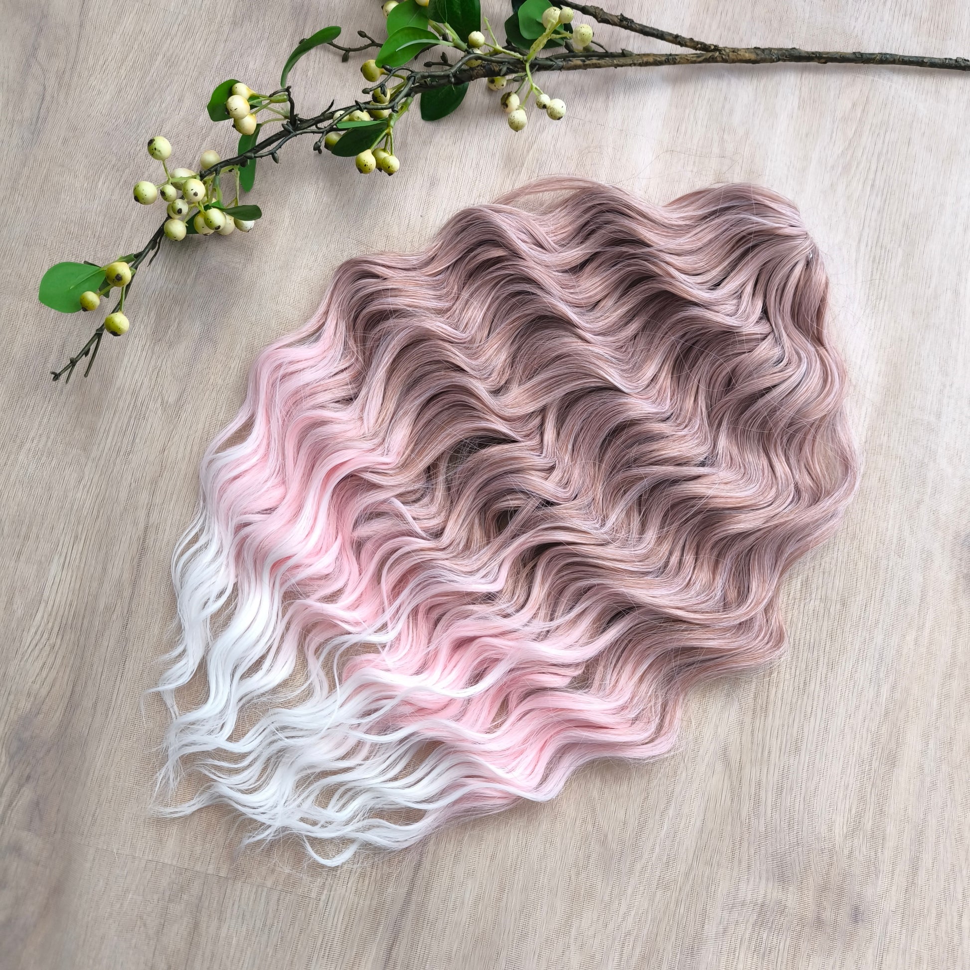 Soft lightweight and reusable brushable curls (regular dreaded, braided middle or pushup): gentle ombré that fades from muted beige-rose at the roots to pastel pink and soft white at the tips. The palette is calm yet expressive, giving a soft, romantic look without being overly bright.