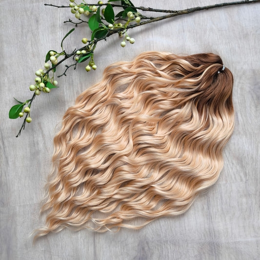 Soft, lightweight, and reusable synthetic brushable double ended wavy dreadlocks. The base starts with a warm chocolate chestnut at the roots, blending seamlessly into a sandy honey blonde with subtle creamy peach undertones. 
