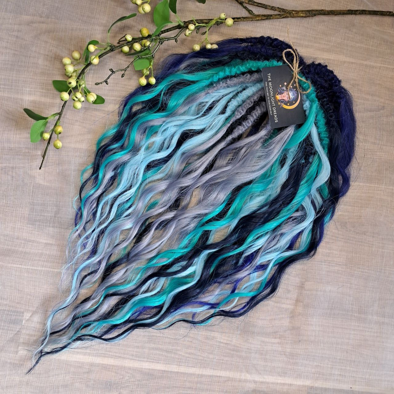 Dive into the deep with Ocean Storm - a powerful mix of midnight and navy blue, turquoise, teal, and icy silver that flows like wild ocean waves. Bold, refreshing, and mysterious - this set is perfect for those who love dramatic contrasts and want their look to stand out.

Soft, lightweight, and reusable custom synthetic brushable double ended curls, a mix of Anna and Body wave (regular dreaded, braided middle or push-up).