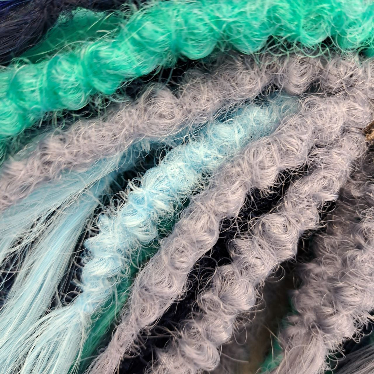 Dive into the deep with Ocean Storm - a powerful mix of midnight and navy blue, turquoise, teal, and icy silver that flows like wild ocean waves. Bold, refreshing, and mysterious - this set is perfect for those who love dramatic contrasts and want their look to stand out.

Soft, lightweight, and reusable custom synthetic brushable double ended curls, a mix of Anna and Body wave (regular dreaded, braided middle or push-up).