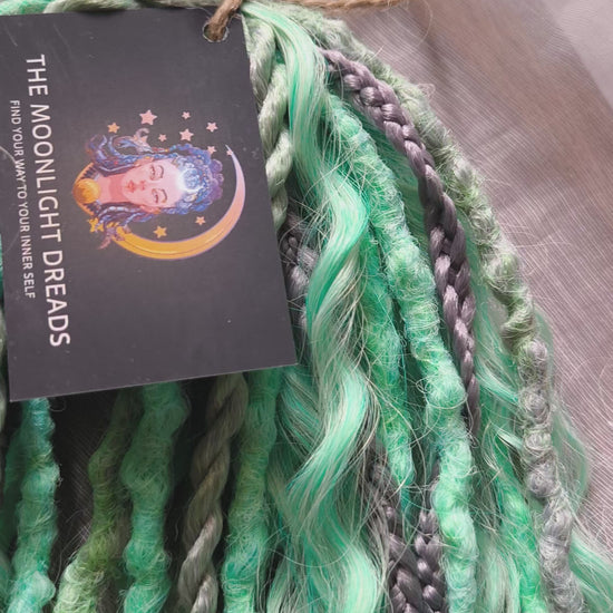 Silver Mint: soft, lightweight, and reusable 20 double ended synthetic crochet dreadlocks, braids, and non-brushable curls in a soft blend of silver and aquamarine.

